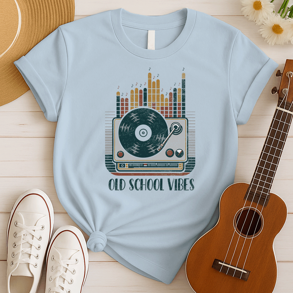 A vibrant, distressed graphic featuring a large turntable with a vinyl record spinning, its tone arm positioned over the record. Behind the turntable, vertical equalizer bars in shades of brown, orange, yellow, and red rise upwards, with small music notes floating above them. Bold, distressed text reads "OLD SCHOOL VIBES". The design evokes retro music and DJ culture.