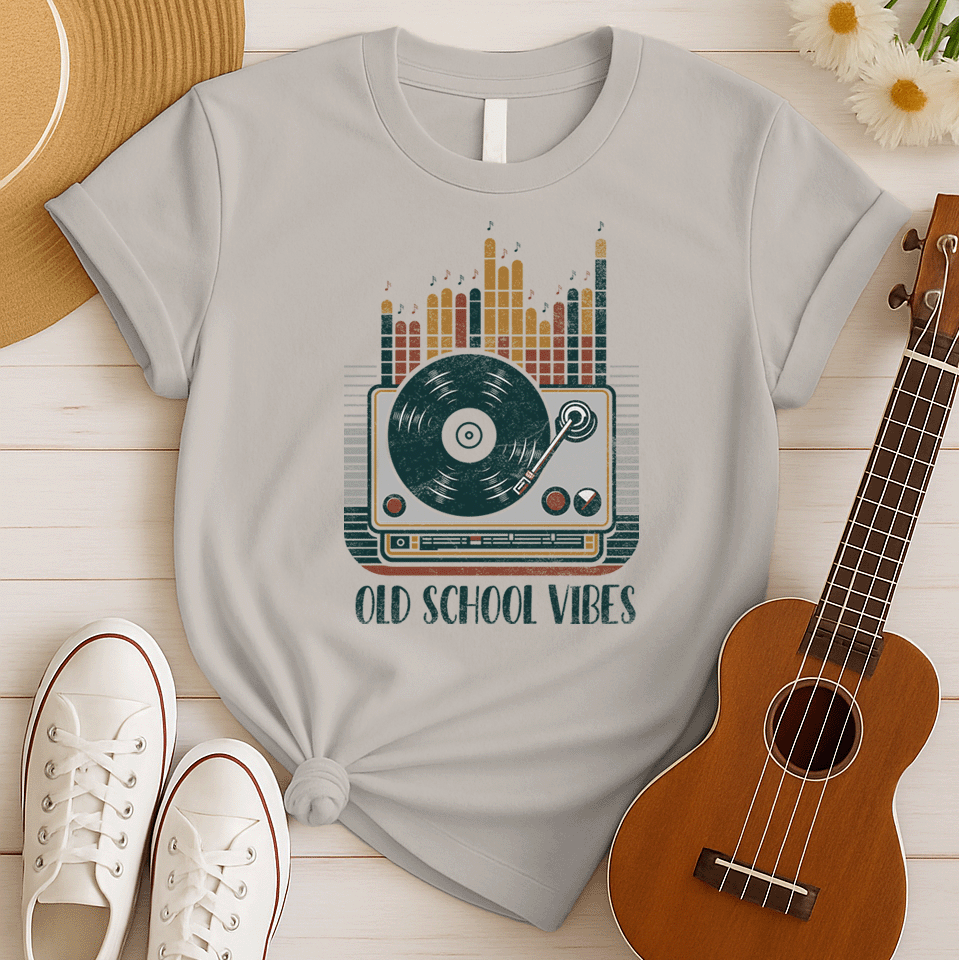 A vibrant, distressed graphic featuring a large turntable with a vinyl record spinning, its tone arm positioned over the record. Behind the turntable, vertical equalizer bars in shades of brown, orange, yellow, and red rise upwards, with small music notes floating above them. Bold, distressed text reads "OLD SCHOOL VIBES". The design evokes retro music and DJ culture.