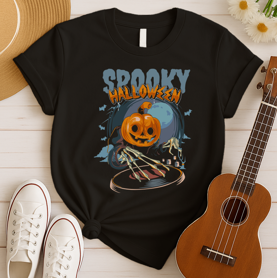 A black background features the distressed light blue text "SPOOKY" and distressed orange text "HALLOWEEN" with a white outline at the top. Below, a large, smiling jack-o'-lantern (pumpkin head) wearing a dark cloak is shown operating a DJ turntable. Skeletal hands with long fingers extend from the cloak over the turntable, manipulating it. In the background, there's a large, pale full moon, silhouetted bats flying, and cloud-like mist. The design represents a Halloween-themed DJ ready for a spooky music pa