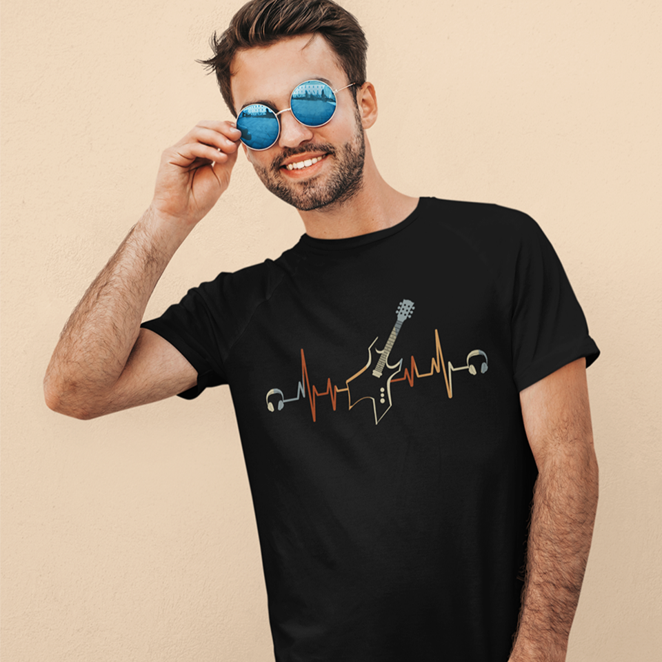 A striking graphic design presents a black electric guitar, notable for its sharp, angular body and a light blue fretboard, positioned centrally within a vibrant, horizontally stretching electrocardiogram (ECG) heartbeat line that shifts from warm reds and oranges to cooler yellows and light blues. A pair of white over-ear headphones are situated at either extremity of the heartbeat line, symbolizing the energetic connection between musical passion and the rhythm of life