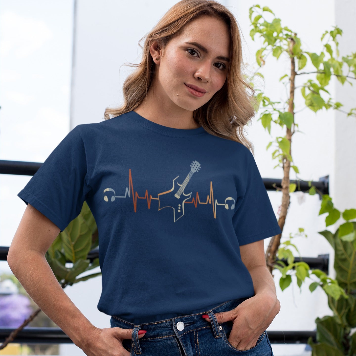 A striking graphic design presents a black electric guitar, notable for its sharp, angular body and a light blue fretboard, positioned centrally within a vibrant, horizontally stretching electrocardiogram (ECG) heartbeat line that shifts from warm reds and oranges to cooler yellows and light blues. A pair of white over-ear headphones are situated at either extremity of the heartbeat line, symbolizing the energetic connection between musical passion and the rhythm of life