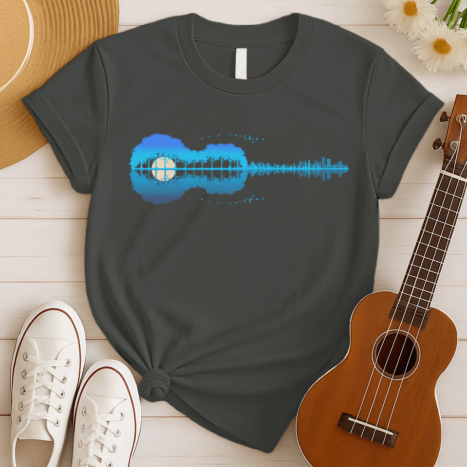 A horizontal silhouette of an acoustic guitar, its body formed by lush, dense trees in shades of blue and purple, with a large, pale yellow moon or sun visible through a clearing in the trees, forming the soundhole. The neck of the guitar transitions into a vibrant blue sound wave or equalizer graphic, which then evolves into a cityscape of buildings. A flock of small, dark birds flies in an arc above the trees, with a smaller flock near the bottom, creating a serene yet dynamic musical landscape.