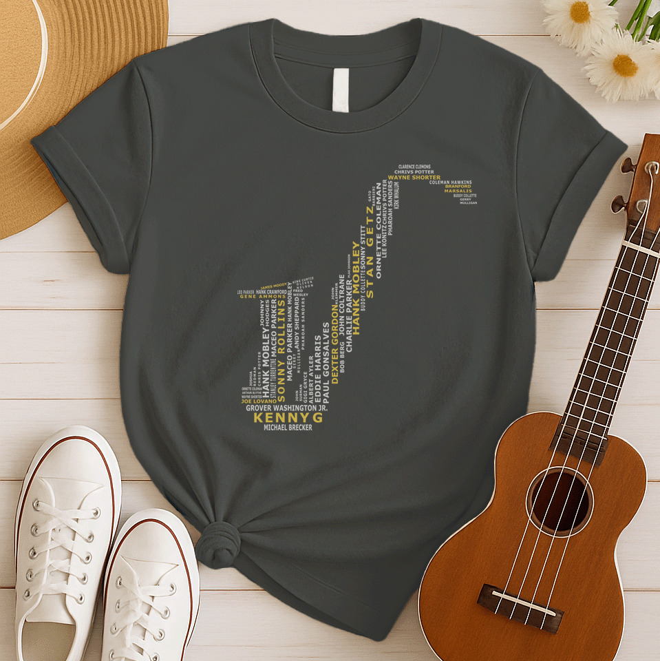 A creative typographic design forms the silhouette of a saxophone using the names of various famous jazz musicians and saxophonists. The names, in white text of varying sizes and fonts, fill the entire shape of the instrument. Prominently featured in larger, bold yellow text at the bottom is "KENNY G", with "MICHAEL BRECKER" directly below it in white, creating a visual tribute to jazz legends.