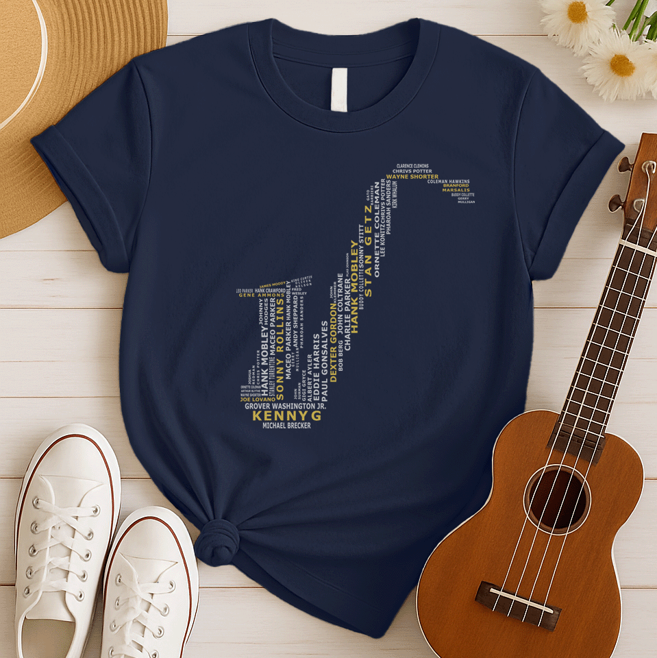 A creative typographic design forms the silhouette of a saxophone using the names of various famous jazz musicians and saxophonists. The names, in white text of varying sizes and fonts, fill the entire shape of the instrument. Prominently featured in larger, bold yellow text at the bottom is "KENNY G", with "MICHAEL BRECKER" directly below it in white, creating a visual tribute to jazz legends.
