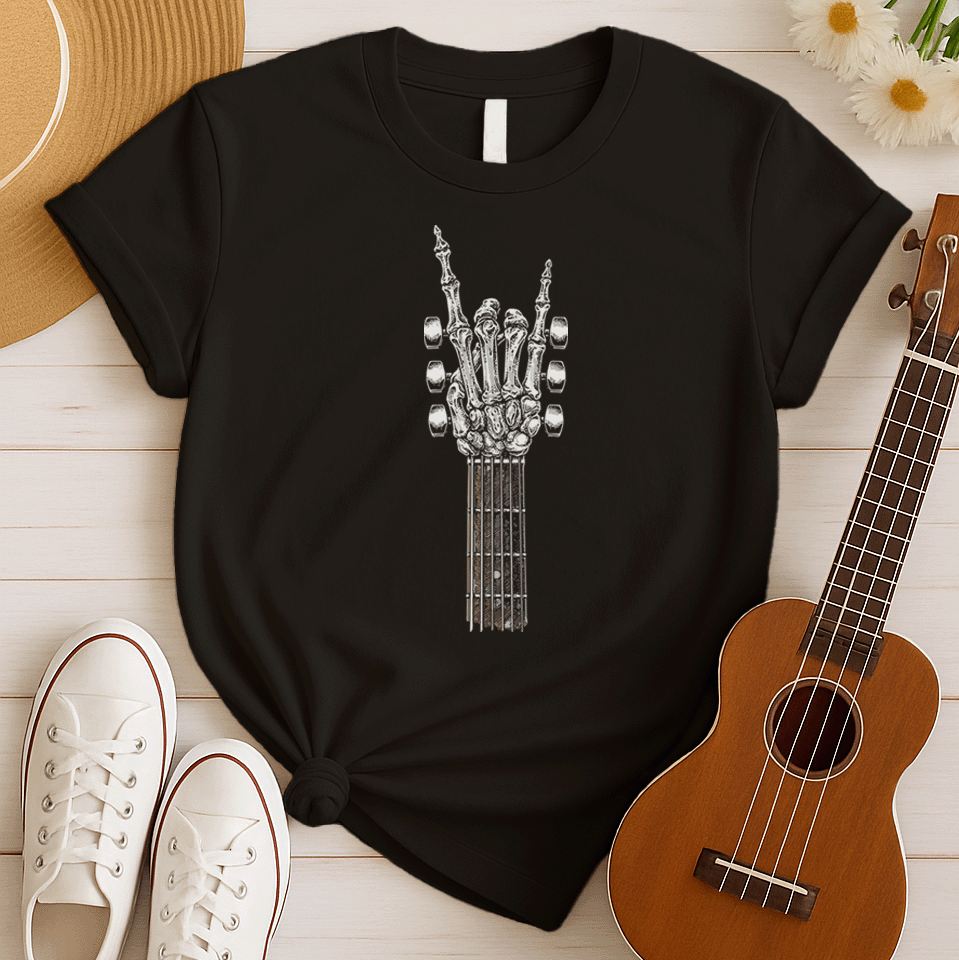 A bold graphic design depicts a skeletal hand forming the classic "rock and roll" sign, with the index and pinky fingers extended upwards, and the thumb holding down the middle two fingers. The hand, rendered in a detailed bone-like texture with shades of white and gray, is positioned at the top of a guitar fretboard, which features brown and white frets and tuning pegs on either side. This powerful image symbolizes the enduring spirit of rock music and its connection to the eternal nature of this genre.