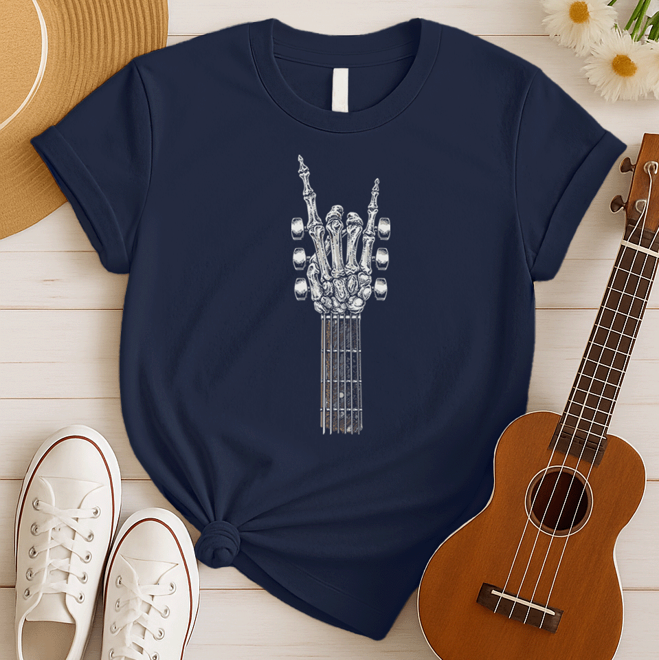 A bold graphic design depicts a skeletal hand forming the classic "rock and roll" sign, with the index and pinky fingers extended upwards, and the thumb holding down the middle two fingers. The hand, rendered in a detailed bone-like texture with shades of white and gray, is positioned at the top of a guitar fretboard, which features brown and white frets and tuning pegs on either side. This powerful image symbolizes the enduring spirit of rock music and its connection to the eternal nature of this genre.