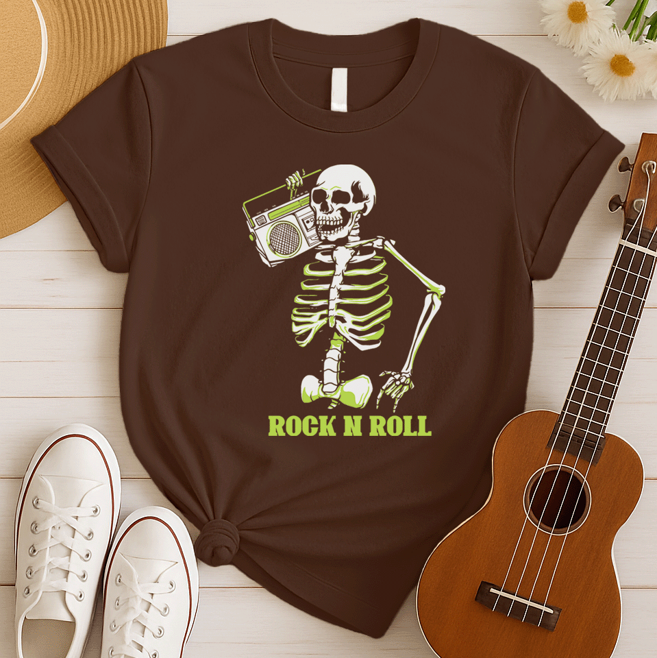 A striking graphic design features a full skeleton, rendered in white with a vibrant lime green glow on its bones, posed in a dynamic, walking stance. The skeleton holds a detailed, white outline of a retro boombox over its right shoulder. Below the skeleton, the bold, lime green text "ROCK N ROLL" is prominently displayed, creating a cool, energetic, and slightly spooky tribute to classic music.