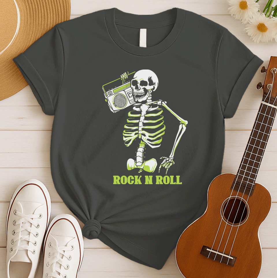 A striking graphic design features a full skeleton, rendered in white with a vibrant lime green glow on its bones, posed in a dynamic, walking stance. The skeleton holds a detailed, white outline of a retro boombox over its right shoulder. Below the skeleton, the bold, lime green text "ROCK N ROLL" is prominently displayed, creating a cool, energetic, and slightly spooky tribute to classic music.