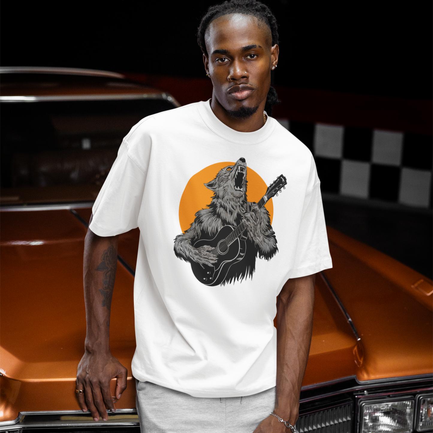 A fierce graphic design showcases a roaring werewolf, rendered in shades of grey and black with piercing orange eyes, powerfully playing an acoustic guitar. The werewolf's head is tilted back, howling, and its sharp teeth and tongue are visible. Behind the creature, a large, vibrant orange circle creates a dramatic backdrop, reminiscent of a full moon or fiery sun. The entire composition conveys a raw, untamed passion for music and a connection to supernatural energy