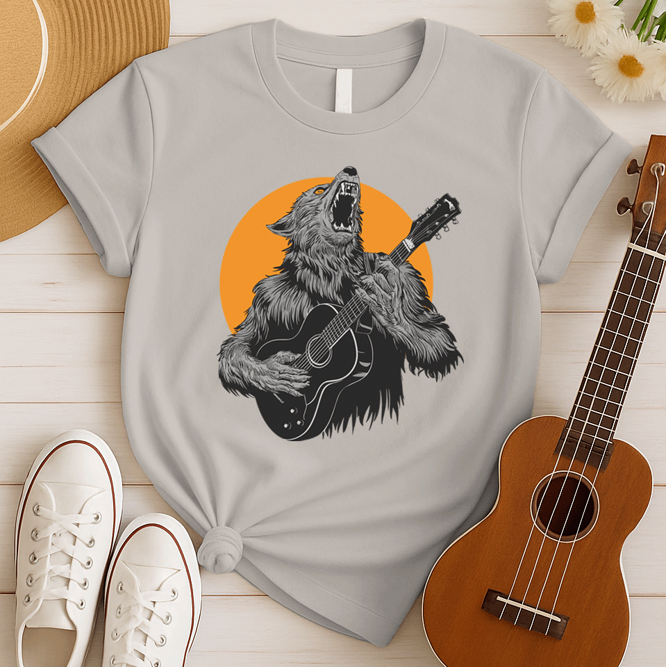 A fierce graphic design showcases a roaring werewolf, rendered in shades of grey and black with piercing orange eyes, powerfully playing an acoustic guitar. The werewolf's head is tilted back, howling, and its sharp teeth and tongue are visible. Behind the creature, a large, vibrant orange circle creates a dramatic backdrop, reminiscent of a full moon or fiery sun. The entire composition conveys a raw, untamed passion for music and a connection to supernatural energy