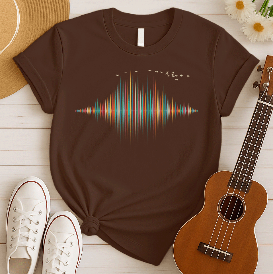 A dynamic graphic design showcases a colorful sound equalizer or sound wave, with vertical bars of varying heights in shades of red, orange, green, blue, and yellow. The bars appear to rise from and reflect into a central horizontal axis, creating a symmetrical visual representation of sound. A flock of small, light-colored birds flies in an arc across the top right of the design, adding a sense of movement. The entire vibrant composition symbolizes music, audio, or a vibrant auditory experience.