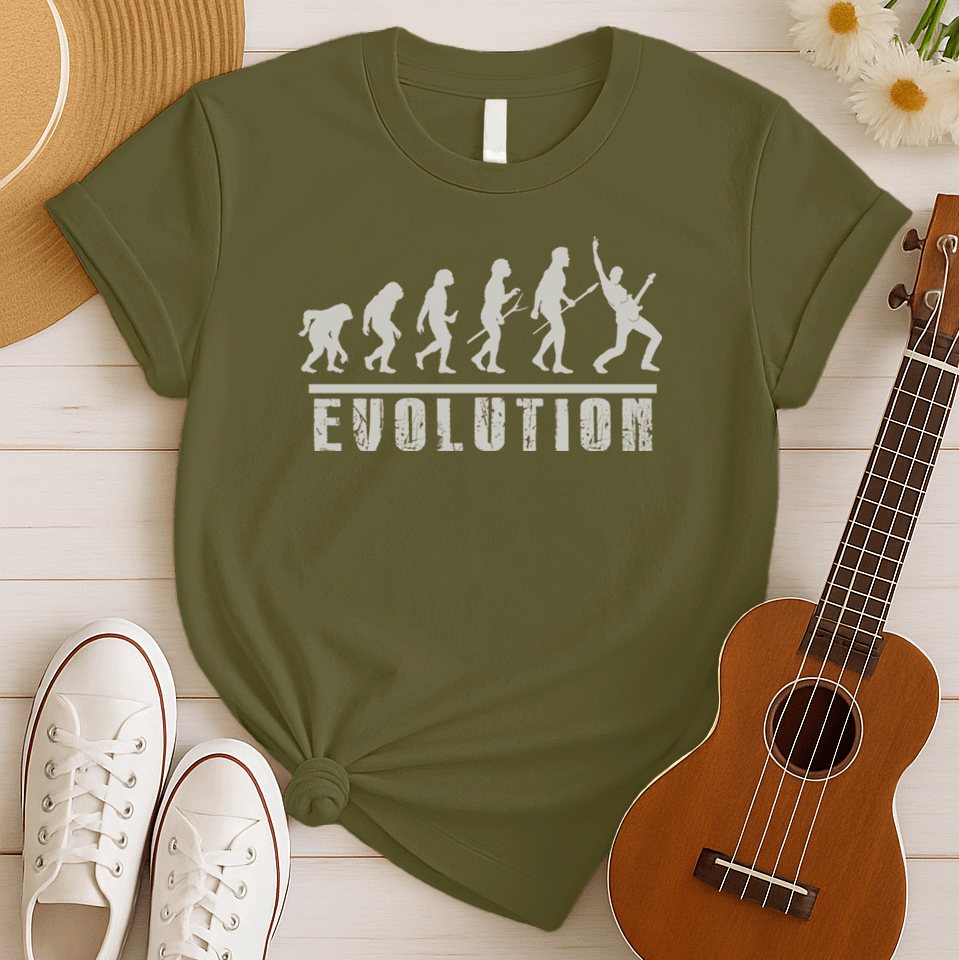 A striking graphic design illustrates the "Evolution of Man" in a sequence of white silhouettes against a black background, beginning with an ape-like figure and progressing through various stages of hominid development. The final figure in the evolutionary chain is a modern human, dynamically playing an electric guitar and raising a "rock on" hand gesture, symbolizing the evolution into a "rockstar." Below the figures, the bold, distressed white word "EVOLUTION" is prominently displayed.