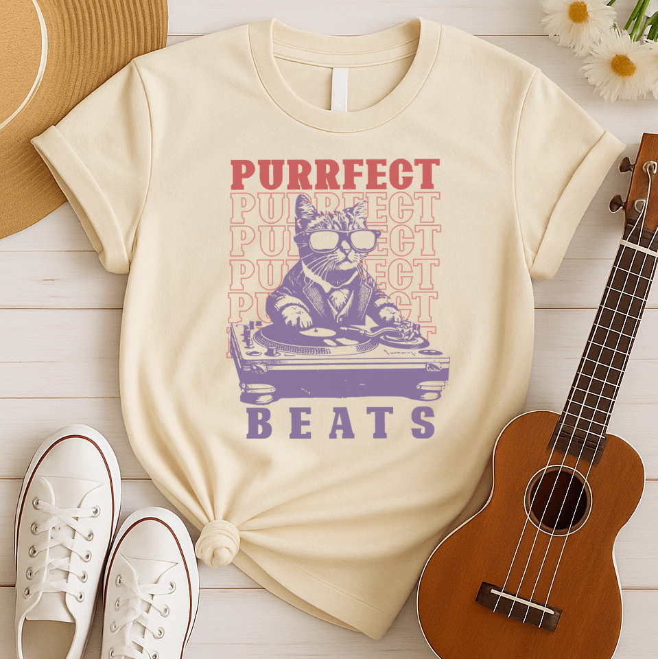 Stylized graphic of a cool purple cat wearing sunglasses and a suit jacket, confidently scratching on a large DJ turntable. Red text repeats "PURRFECT" in the background, and large purple text below reads "BEATS". The design embodies DJ culture, electronic music, and a humorous feline twist, ideal for DJs, cat lovers, and music enthusiasts.
