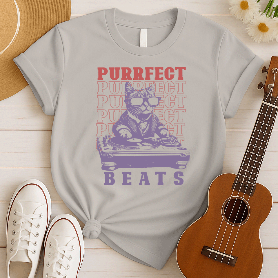 Stylized graphic of a cool purple cat wearing sunglasses and a suit jacket, confidently scratching on a large DJ turntable. Red text repeats "PURRFECT" in the background, and large purple text below reads "BEATS". The design embodies DJ culture, electronic music, and a humorous feline twist, ideal for DJs, cat lovers, and music enthusiasts.