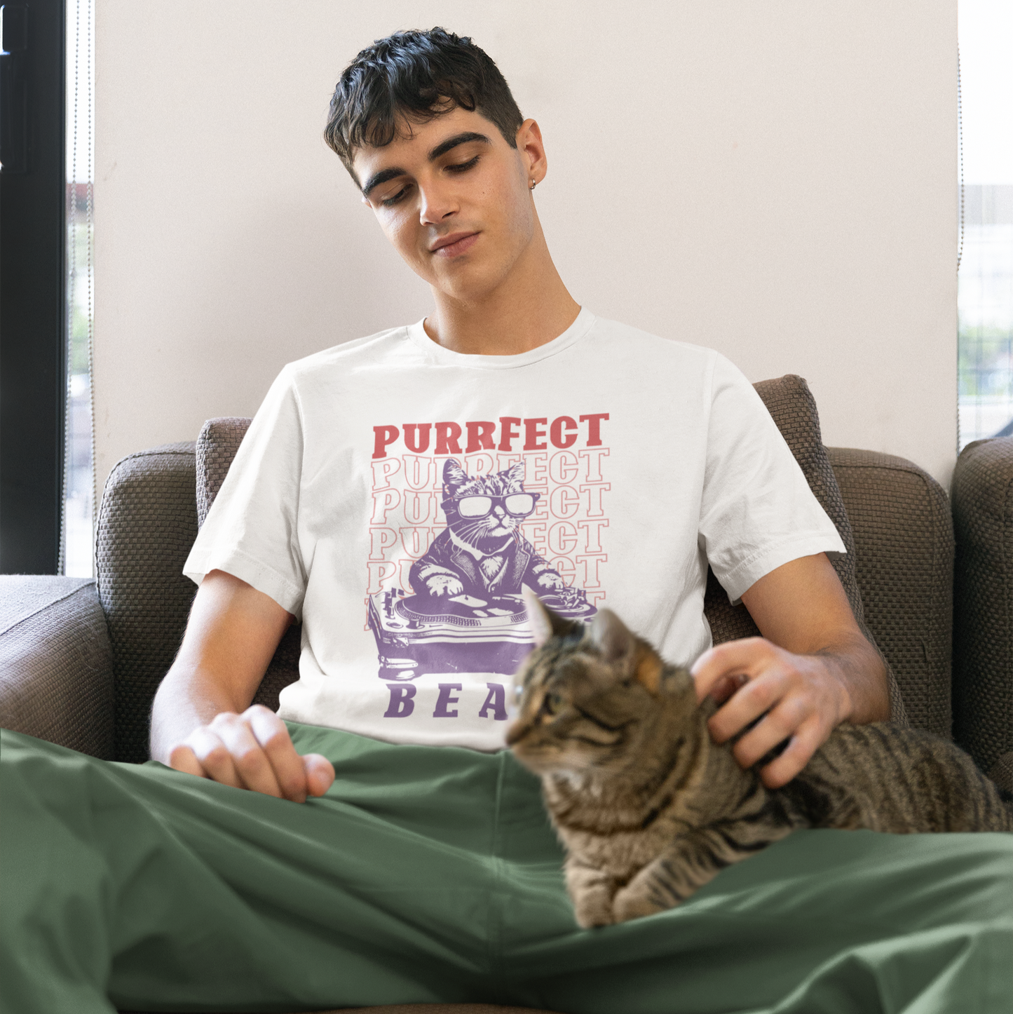 Stylized graphic of a cool purple cat wearing sunglasses and a suit jacket, confidently scratching on a large DJ turntable. Red text repeats "PURRFECT" in the background, and large purple text below reads "BEATS". The design embodies DJ culture, electronic music, and a humorous feline twist, ideal for DJs, cat lovers, and music enthusiasts.