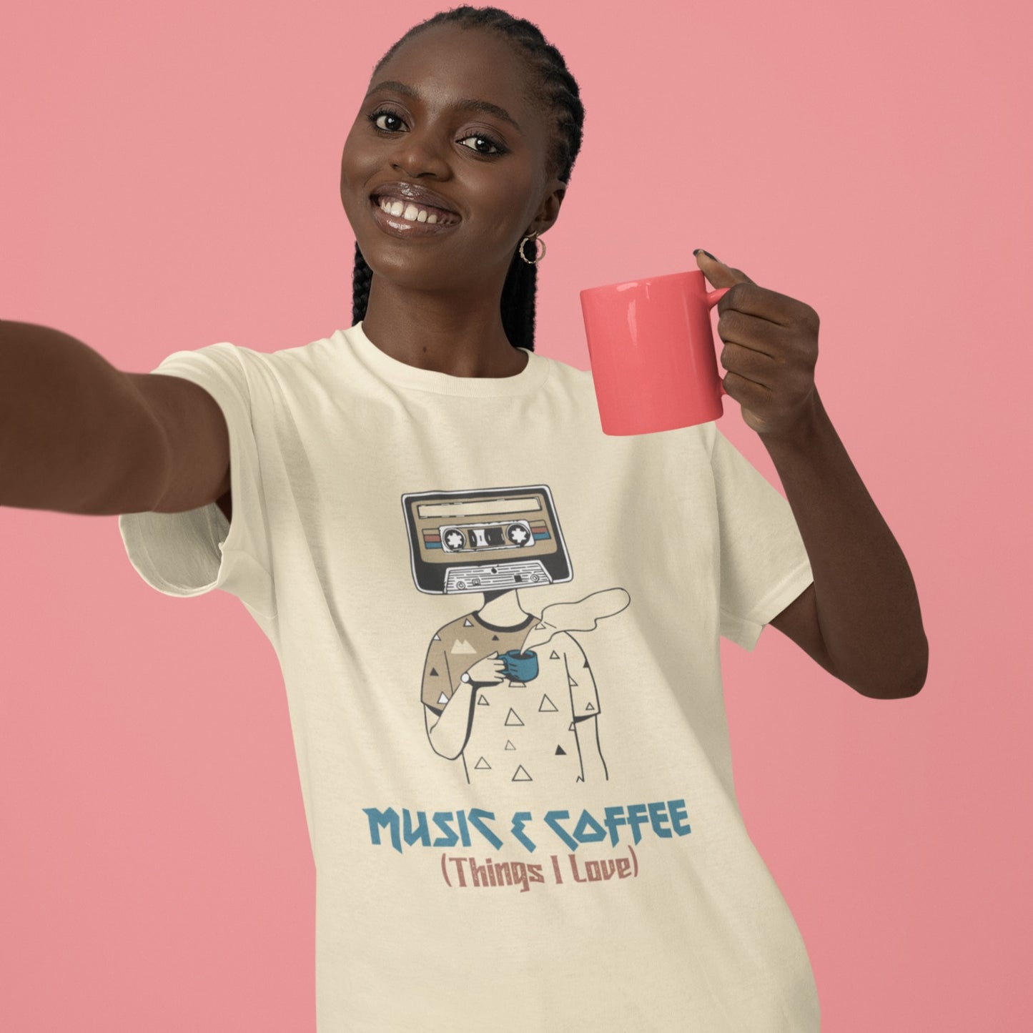 Stylized graphic of a person's body with a vintage brown and black audio cassette tape as its head, holding a blue steaming coffee cup. Small triangle patterns are on the person's beige shirt. Blue distressed text below reads "MUSIC & COFFEE" and red text below that says "(Things I Love)". The design embodies music appreciation, coffee love, and retro nostalgia, ideal for music lovers and coffee enthusiasts.