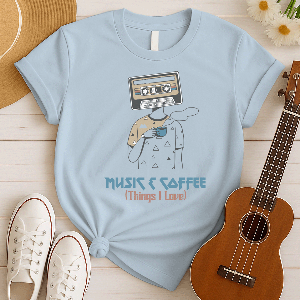 Stylized graphic of a person's body with a vintage brown and black audio cassette tape as its head, holding a blue steaming coffee cup. Small triangle patterns are on the person's beige shirt. Blue distressed text below reads "MUSIC & COFFEE" and red text below that says "(Things I Love)". The design embodies music appreciation, coffee love, and retro nostalgia, ideal for music lovers and coffee enthusiasts.