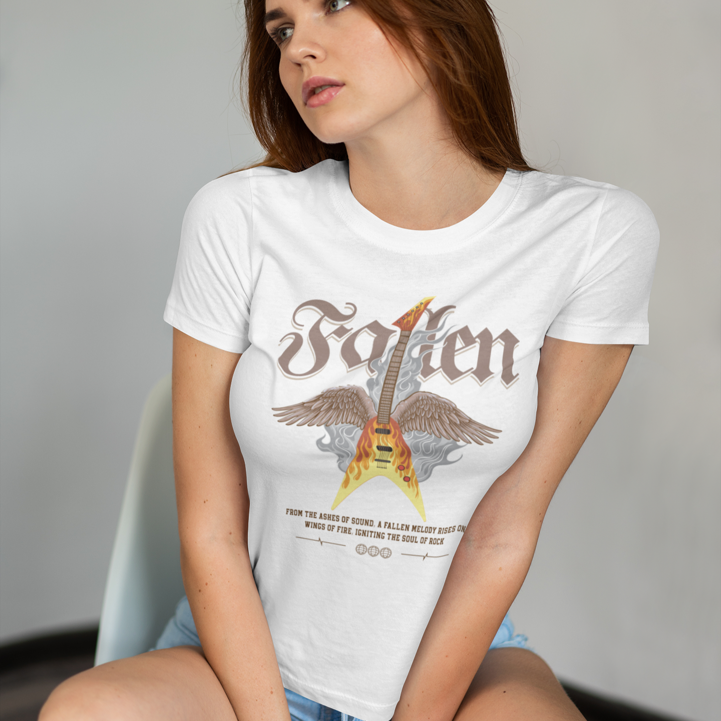 Dramatic graphic featuring a vibrant yellow and orange electric guitar engulfed in flames with large brown feathered wings, rising from grey smoke. The design powerfully symbolizes the resurrection and enduring spirit of rock and metal music, driven by a fiery guitar, ideal for guitar lovers and hard rock fans.