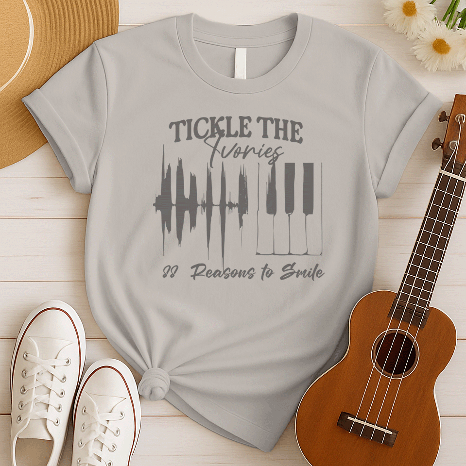 A light grey background features a graphic with a jagged sound wave transitioning into a set of classic piano keys in dark grey. Below the graphic, dark grey text reads "88 Reasons to Smile". The design prominently features text at the top, "TICKLE THE Ivories". This image symbolizes the joy of music, piano playing, and musical happiness, ideal for pianists and music enthusiasts.