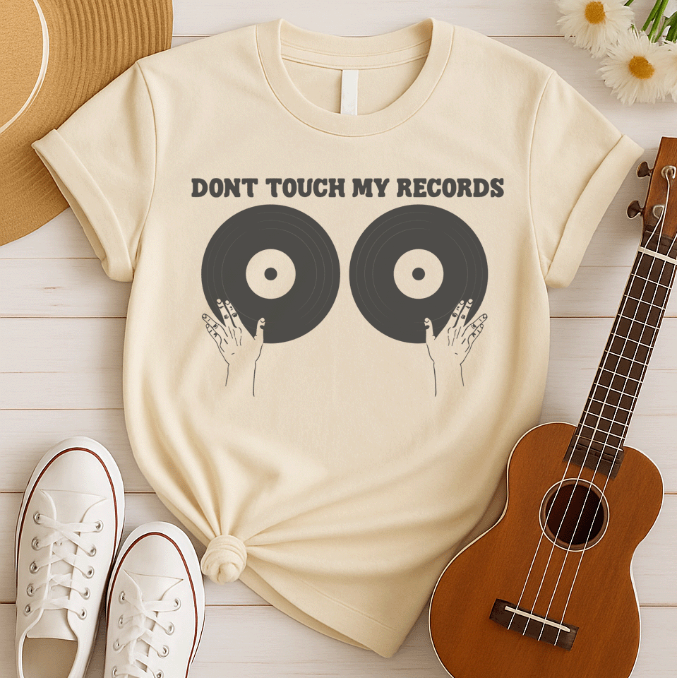 A black background features the bold, capitalized text "DONT TOUCH MY RECORDS" at the top. Below, two large, dark grey vinyl records are depicted side-by-side, with two outlined hands reaching up from the bottom, appearing to cup or touch the records. The design is humorous, symbolizing a possessive love for music, vinyl records, and record collecting, ideal for audiophiles and music fans.