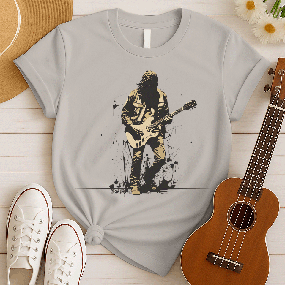 A striking graphic design depicts a silhouetted rock musician, with dark, flowing hair and a black outline, intensely playing a light beige electric guitar. The musician wears a detailed beige jacket and pants, with their form subtly highlighted against the darker background. Splatters of black paint or ink are visible around the musician's feet, adding a raw, energetic, and slightly rebellious aesthetic to the overall composition.
