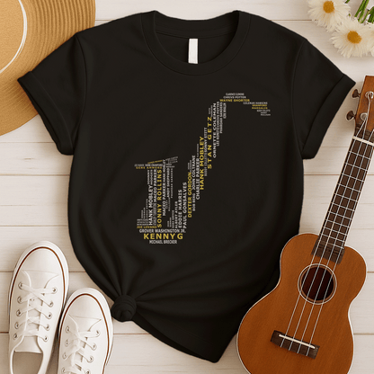 A creative typographic design forms the silhouette of a saxophone using the names of various famous jazz musicians and saxophonists. The names, in white text of varying sizes and fonts, fill the entire shape of the instrument. Prominently featured in larger, bold yellow text at the bottom is "KENNY G", with "MICHAEL BRECKER" directly below it in white, creating a visual tribute to jazz legends.