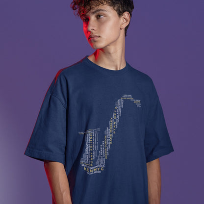 A creative typographic design forms the silhouette of a saxophone using the names of various famous jazz musicians and saxophonists. The names, in white text of varying sizes and fonts, fill the entire shape of the instrument. Prominently featured in larger, bold yellow text at the bottom is "KENNY G", with "MICHAEL BRECKER" directly below it in white, creating a visual tribute to jazz legends.