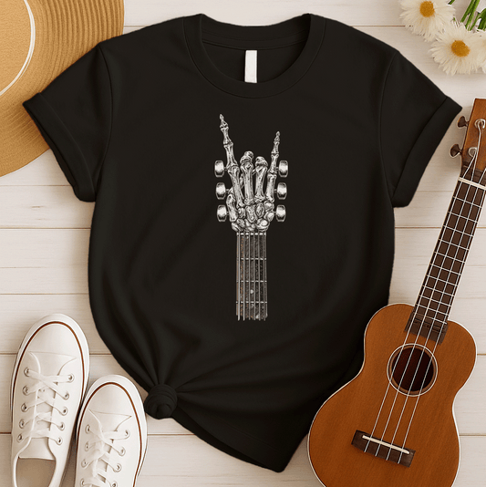 A bold graphic design depicts a skeletal hand forming the classic "rock and roll" sign, with the index and pinky fingers extended upwards, and the thumb holding down the middle two fingers. The hand, rendered in a detailed bone-like texture with shades of white and gray, is positioned at the top of a guitar fretboard, which features brown and white frets and tuning pegs on either side. This powerful image symbolizes the enduring spirit of rock music and its connection to the eternal nature of this genre.