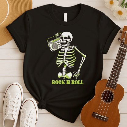 A striking graphic design features a full skeleton, rendered in white with a vibrant lime green glow on its bones, posed in a dynamic, walking stance. The skeleton holds a detailed, white outline of a retro boombox over its right shoulder. Below the skeleton, the bold, lime green text "ROCK N ROLL" is prominently displayed, creating a cool, energetic, and slightly spooky tribute to classic music.