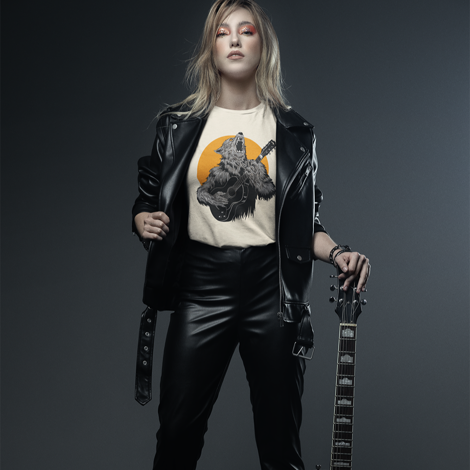 A fierce graphic design showcases a roaring werewolf, rendered in shades of grey and black with piercing orange eyes, powerfully playing an acoustic guitar. The werewolf's head is tilted back, howling, and its sharp teeth and tongue are visible. Behind the creature, a large, vibrant orange circle creates a dramatic backdrop, reminiscent of a full moon or fiery sun. The entire composition conveys a raw, untamed passion for music and a connection to supernatural energy