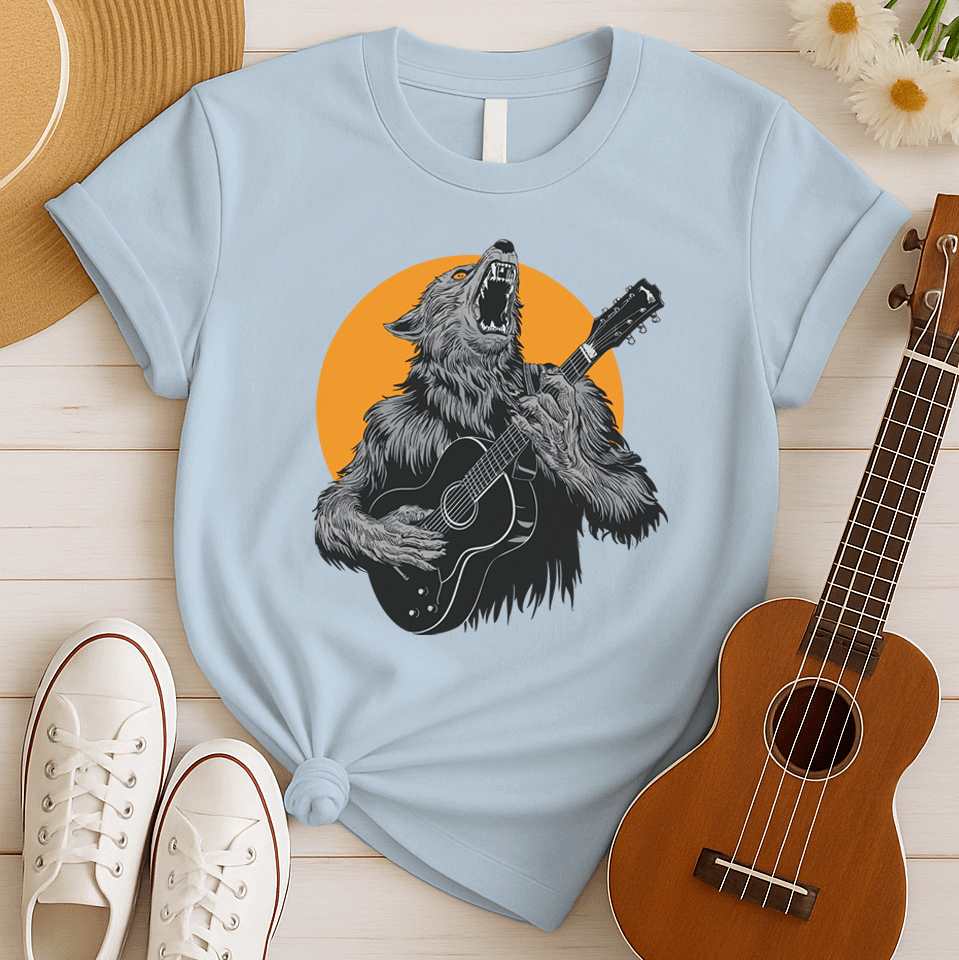 A fierce graphic design showcases a roaring werewolf, rendered in shades of grey and black with piercing orange eyes, powerfully playing an acoustic guitar. The werewolf's head is tilted back, howling, and its sharp teeth and tongue are visible. Behind the creature, a large, vibrant orange circle creates a dramatic backdrop, reminiscent of a full moon or fiery sun. The entire composition conveys a raw, untamed passion for music and a connection to supernatural energy
