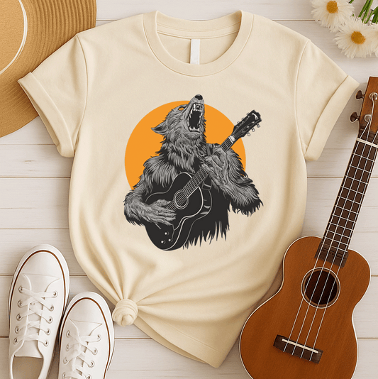 A fierce graphic design showcases a roaring werewolf, rendered in shades of grey and black with piercing orange eyes, powerfully playing an acoustic guitar. The werewolf's head is tilted back, howling, and its sharp teeth and tongue are visible. Behind the creature, a large, vibrant orange circle creates a dramatic backdrop, reminiscent of a full moon or fiery sun. The entire composition conveys a raw, untamed passion for music and a connection to supernatural energy