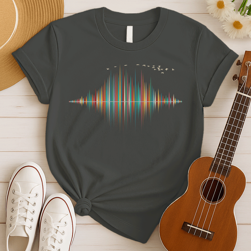 A dynamic graphic design showcases a colorful sound equalizer or sound wave, with vertical bars of varying heights in shades of red, orange, green, blue, and yellow. The bars appear to rise from and reflect into a central horizontal axis, creating a symmetrical visual representation of sound. A flock of small, light-colored birds flies in an arc across the top right of the design, adding a sense of movement. The entire vibrant composition symbolizes music, audio, or a vibrant auditory experience.