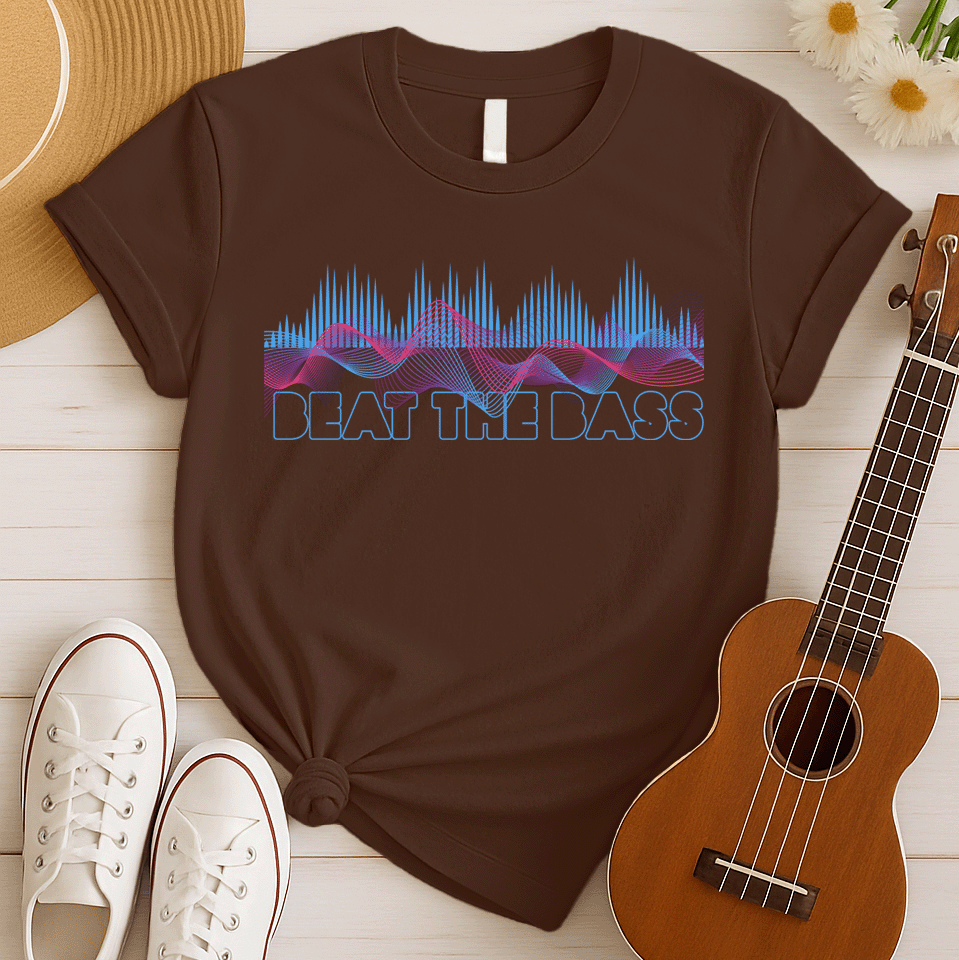 A vibrant graphic design features dynamic pink and blue sound waves undulating across a black background, interspersed with vertical blue equalizer bars that rise and fall. Below these auditory visuals, the phrase "BEAT THE BASS" is rendered in bold, outlined blue text. This energetic composition visually represents powerful bass music and electronic sound.