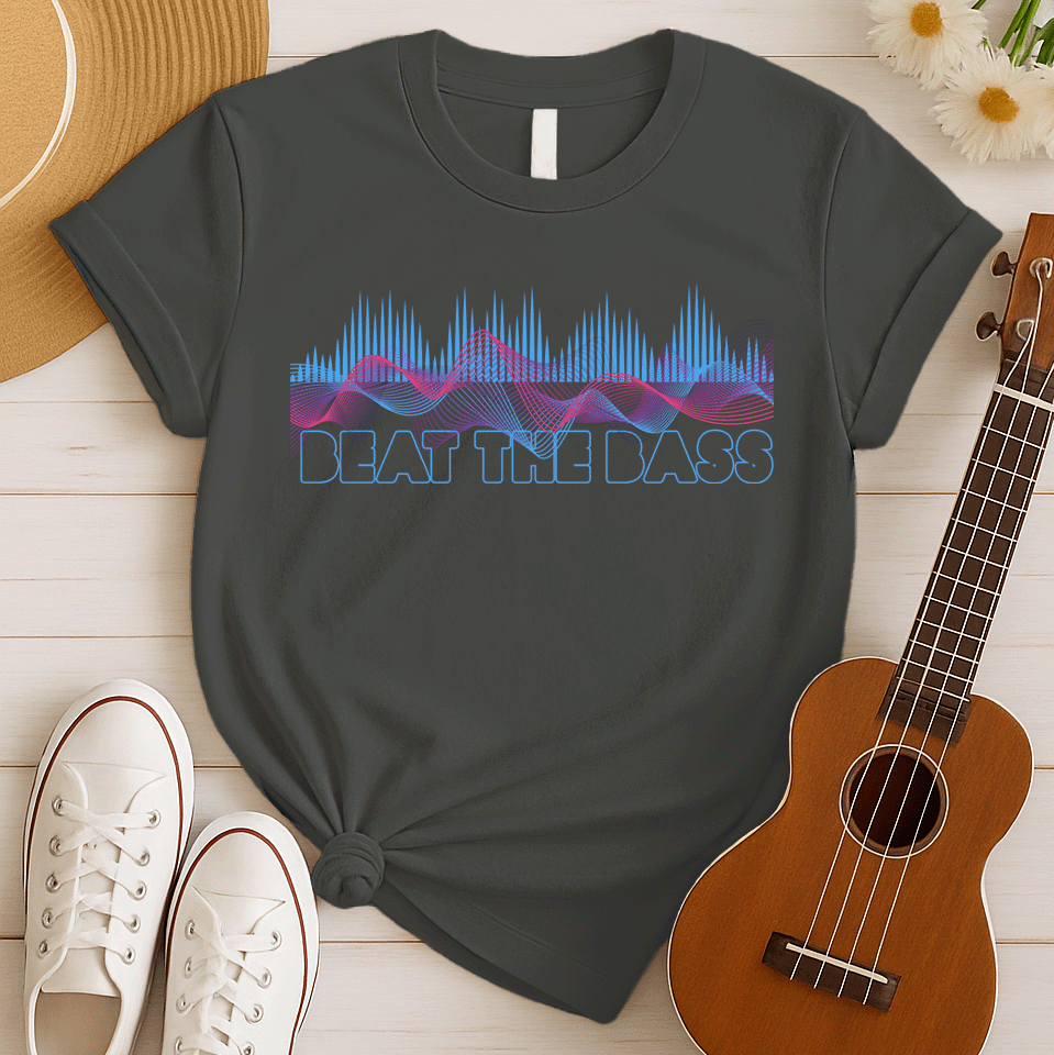 A vibrant graphic design features dynamic pink and blue sound waves undulating across a black background, interspersed with vertical blue equalizer bars that rise and fall. Below these auditory visuals, the phrase "BEAT THE BASS" is rendered in bold, outlined blue text. This energetic composition visually represents powerful bass music and electronic sound.