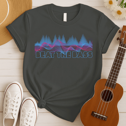 A vibrant graphic design features dynamic pink and blue sound waves undulating across a black background, interspersed with vertical blue equalizer bars that rise and fall. Below these auditory visuals, the phrase "BEAT THE BASS" is rendered in bold, outlined blue text. This energetic composition visually represents powerful bass music and electronic sound.