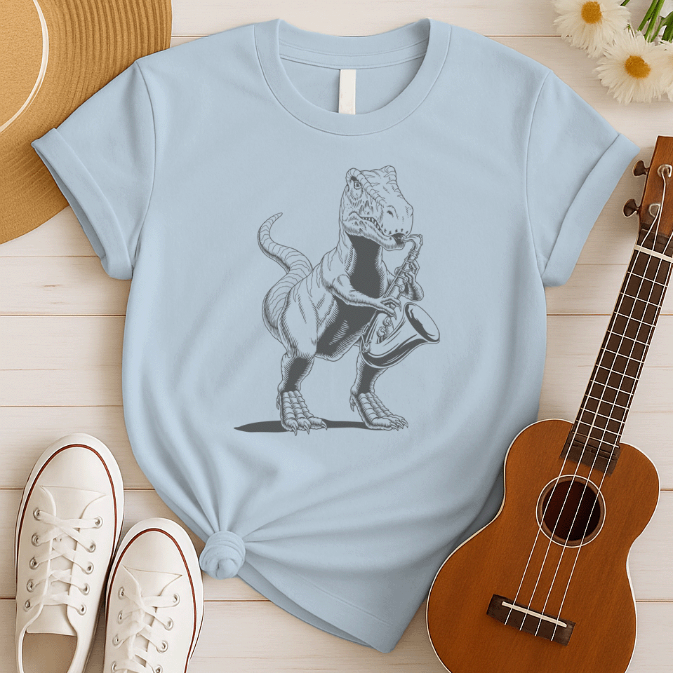 A powerful graphic design depicts a dark grey Tyrannosaurus Rex (T-Rex) holding and seemingly playing a saxophone. The T-Rex is detailed with scales and a strong posture, clutching the saxophone in its small but capable forelimbs. The musical instrument is rendered in a slightly lighter shade of grey, showcasing its keys and bell. This unique illustration, humorously blends prehistoric might with the smooth sounds of jazz or blues.