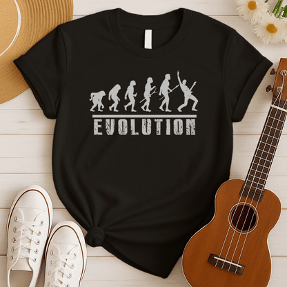 A striking graphic design illustrates the "Evolution of Man" in a sequence of white silhouettes against a black background, beginning with an ape-like figure and progressing through various stages of hominid development. The final figure in the evolutionary chain is a modern human, dynamically playing an electric guitar and raising a "rock on" hand gesture, symbolizing the evolution into a "rockstar." Below the figures, the bold, distressed white word "EVOLUTION" is prominently displayed.