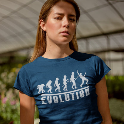 A striking graphic design illustrates the "Evolution of Man" in a sequence of white silhouettes against a black background, beginning with an ape-like figure and progressing through various stages of hominid development. The final figure in the evolutionary chain is a modern human, dynamically playing an electric guitar and raising a "rock on" hand gesture, symbolizing the evolution into a "rockstar." Below the figures, the bold, distressed white word "EVOLUTION" is prominently displayed.