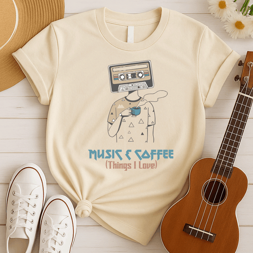 Stylized graphic of a person's body with a vintage brown and black audio cassette tape as its head, holding a blue steaming coffee cup. Small triangle patterns are on the person's beige shirt. Blue distressed text below reads "MUSIC & COFFEE" and red text below that says "(Things I Love)". The design embodies music appreciation, coffee love, and retro nostalgia, ideal for music lovers and coffee enthusiasts.