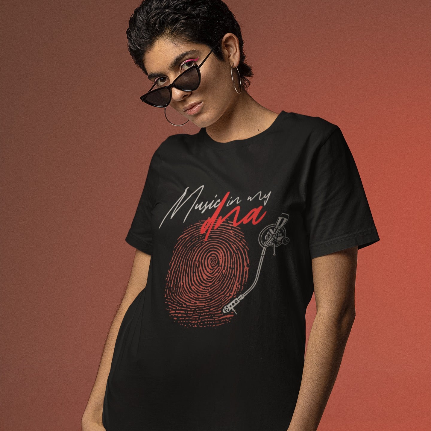Stylized graphic of a large red fingerprint that is designed like the grooves of a vinyl record, with a white turntable tonearm and needle positioned on it. Above, white handwritten text says "Music in my" and red stylized text says "dna". The design perfectly symbolizes an inherent passion for music, vinyl records, and unique identity, ideal for music lovers and DJs.