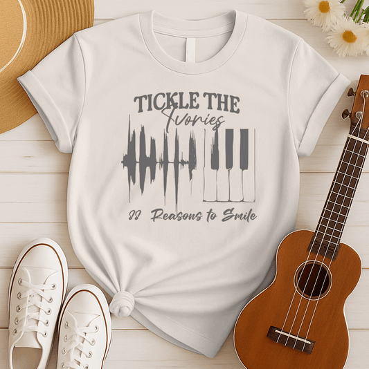 A light background features a graphic with a jagged sound wave transitioning into a set of classic piano keys in dark grey. Below the graphic, dark grey text reads "88 Reasons to Smile". The design prominently features text at the top, "TICKLE THE Ivories". This image symbolizes the joy of music, piano playing, and musical happiness, ideal for pianists and music enthusiasts.