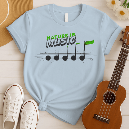 A black background features the text "NATURE IS" in a distressed green font at the top. Below it, the word "MUSIC" is prominently displayed in a larger, distressed dark grey font with a subtle 3D effect. Below the text, a horizontal musical staff is shown with five round, dark grey quarter notes. Each note has a small green leaf growing from its stem, with the last note having a larger, more prominent green leaf. The design symbolizes the connection between nature and music, perfect for environmentalists an
