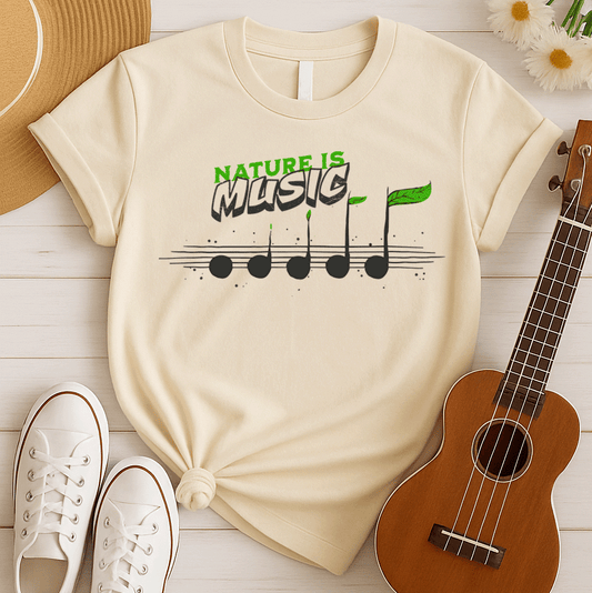 A black background features the text "NATURE IS" in a distressed green font at the top. Below it, the word "MUSIC" is prominently displayed in a larger, distressed dark grey font with a subtle 3D effect. Below the text, a horizontal musical staff is shown with five round, dark grey quarter notes. Each note has a small green leaf growing from its stem, with the last note having a larger, more prominent green leaf. The design symbolizes the connection between nature and music, perfect for environmentalists an
