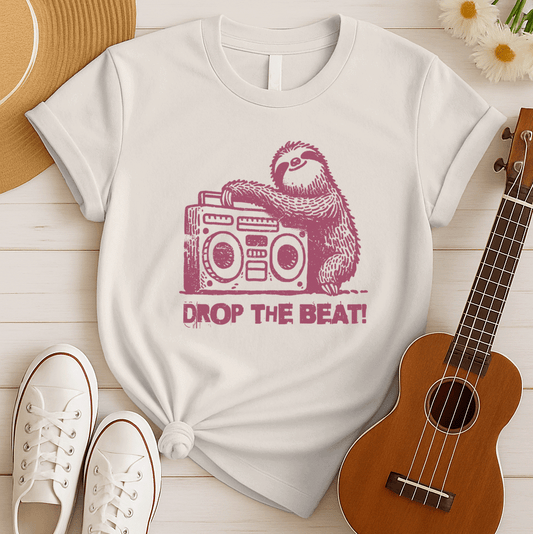 A light grey background features a distressed, red-brown illustration of a fluffy sloth. The sloth is leaning on a large, matching red-brown boombox, which has prominent speakers and controls. Below the sloth and boombox, the distressed text "DROP THE BEAT!" is written in a blocky, red-brown font with a slight splattered effect. The design portrays a relaxed animal enjoying loud music from a retro radio.
