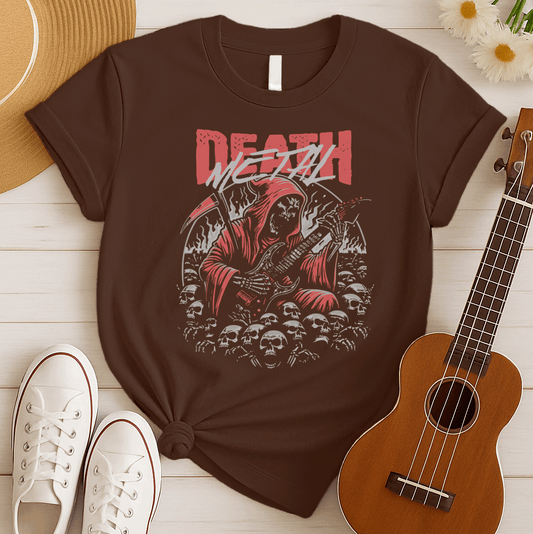 A black background features the distressed red text "DEATH" at the top, with "METAL" in distressed light grey below it. The main image is a detailed illustration of a skeletal Grim Reaper figure in a flowing red hooded robe, holding a large scythe in its left hand and aggressively playing a black electric guitar in its right. The figure is surrounded by many light grey human skulls and ghostly white/grey flames or smoke effects. The design embodies death metal music, dark themes, and guitar performance.