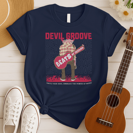 A black background features the distressed red text "DEVIL GROOVE" at the top. Below, a stylized, large figure with horns and shaggy hair/fur, wearing a plaid shirt and brown pants, stands centrally. The figure holds a large, red, abstract guitar-shaped object with the distressed white text "BEATS" and "of FREEDOM" on it. The background also shows repeated outlines of "DEVIL GROOVE" in white. At the bottom, distressed red flames rise, with the text "IGNITE YOUR SOUL EMBRACE THE POWER OF MUSIC". The design p